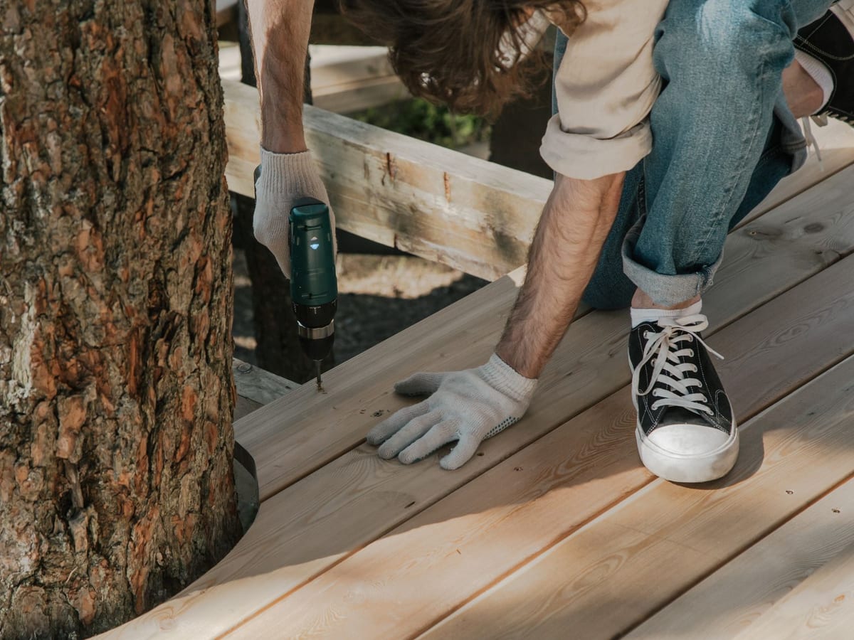 Timber decking boards being laid in a back garden